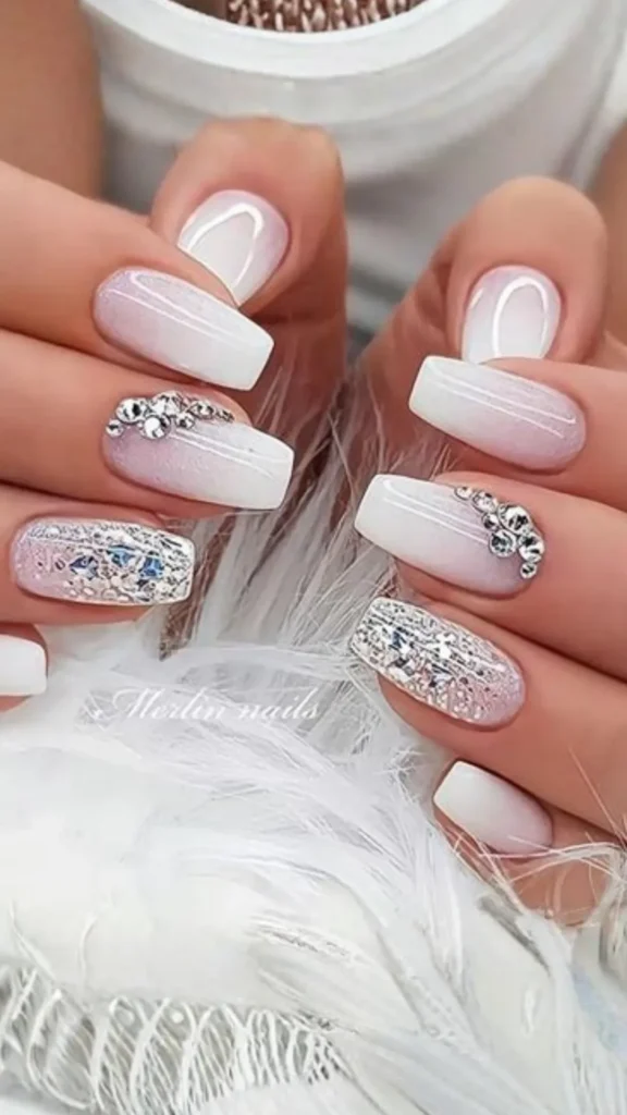 A glamorous bridal manicure on long square nails featuring a clean pink-and-white ombre base. Accent nails are elevated with sparkling clusters of crystals and full-coverage silver holographic glitter.