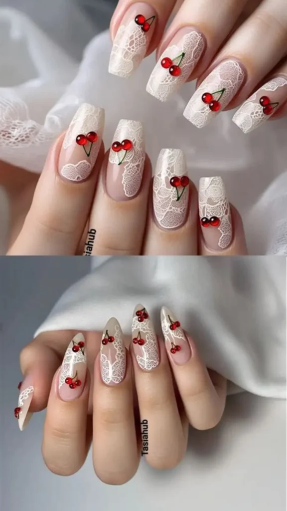 A two-panel image featuring intricate cherry-themed nail art. The top panel shows long coffin nails with a clear base, detailed white lace patterns, and 3D glossy red cherry charms with green stems. The bottom panel displays the exact same white lace and 3D cherry charm design on long, sharp stiletto nails.