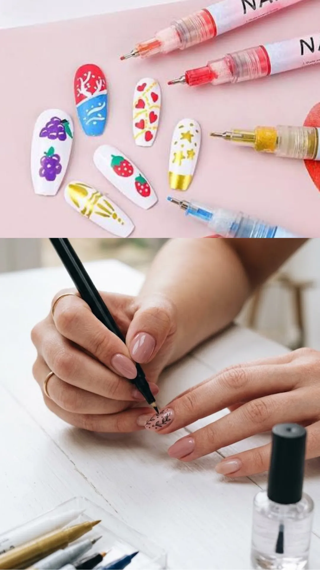 A two-part photograph focusing on modern nail art pens. The top section showcases five plastic false nails decorated with colorful hand-drawn strawberries, grapes, hearts, and gold stars sitting next to fine-tipped liquid nail paint pens. The bottom section depicts a close-up of a person holding a fine black felt-tip nail art pen like a pencil, drawing a miniature botanical vine with leaves onto a glossy, nude-painted fingernail.