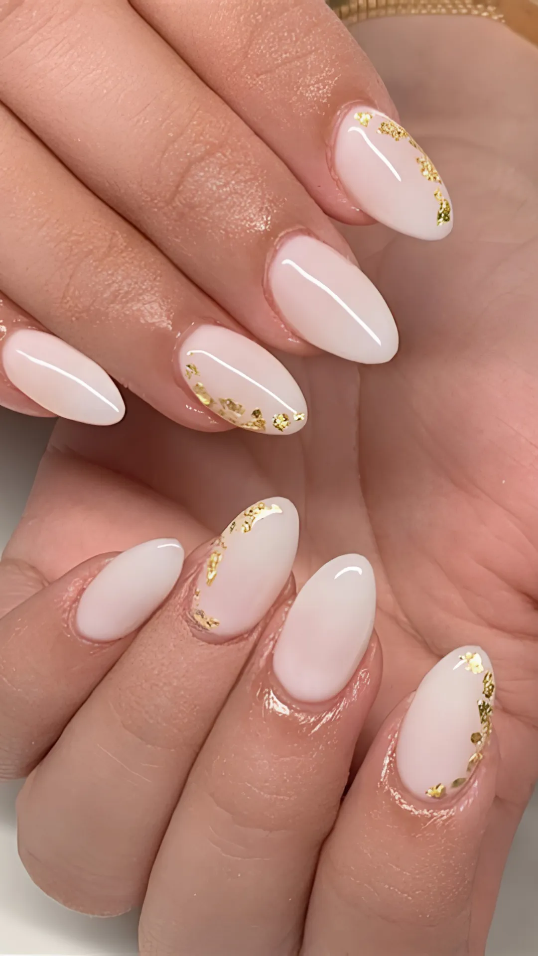 This vibrant image displays short, natural gel nails, each showcasing a distinct and playful abstract pattern. From a distance, the design resembles a checkerboard, but upon inspection, each nail tells a different story. One thumb features bright orange and white yin-yang symbols, while the other displays vertical pink and lime green stripes. Other nails incorporate pink checkerboards, blue swirls on nude, and abstract cow print dots in black on white. The color palette is cheerful and diverse, creating an optimistic and creative vibe. This "Skittles" style mani offers a fun, dynamic way to express individual style with lasting power.