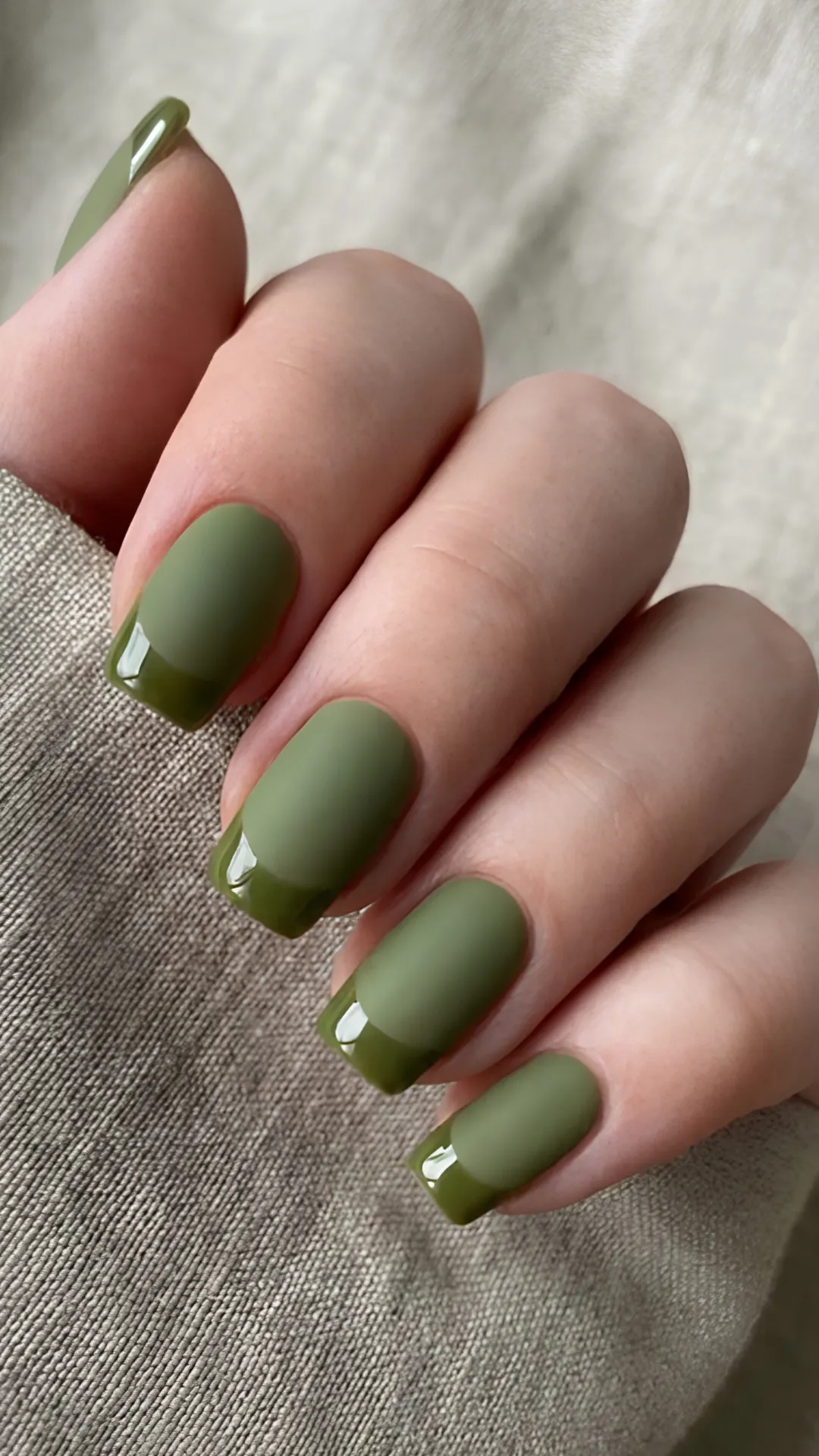 A chic and modern square manicure displaying a matte olive green base paired with matching high-gloss olive green French tips for a subtle texture contrast.
