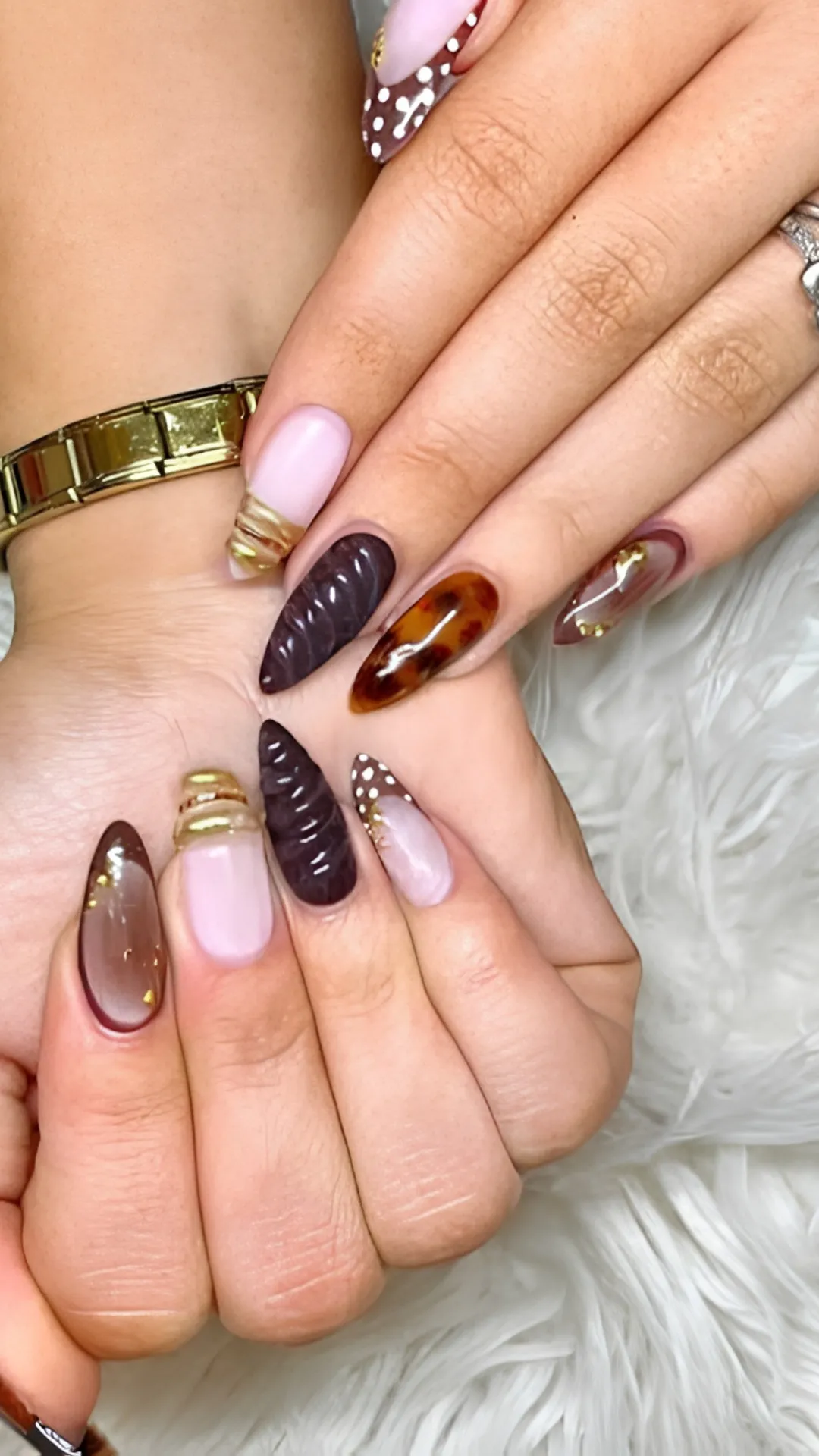 Eclectic autumn stiletto nails showcasing an array of seasonal styles including dark tortoise shell patterns, 3D swirled chocolate gel accents, gold foil cuffs, and white polka dot French tips.